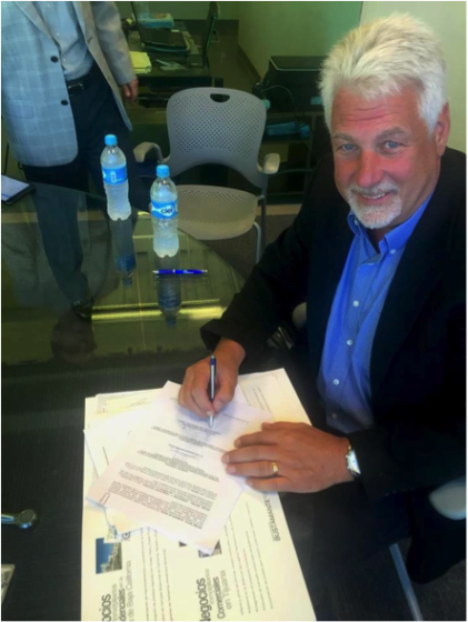 Sean Lambert of YWAM San Diego signs the papers