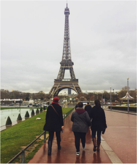 Three YWAMers walking towards the Eiffel Tower along the river in Paris
